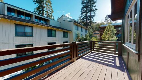a wooden porch with a fence next to a building at Red Slate Canyon - Modern 2-Story Condo in Mammoth Lakes