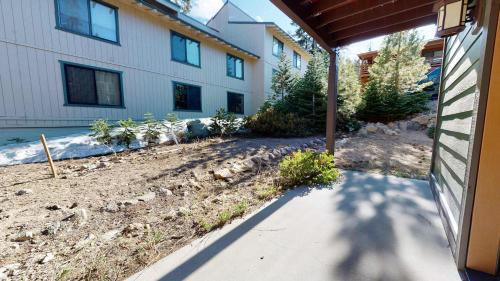a house with a sidewalk next to a building at Red Slate Canyon - Modern 2-Story Condo in Mammoth Lakes