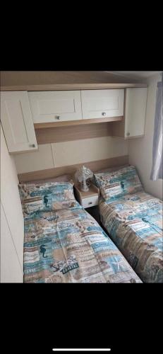 two beds in a small room with at 20 Chestnut Grove in Stranraer