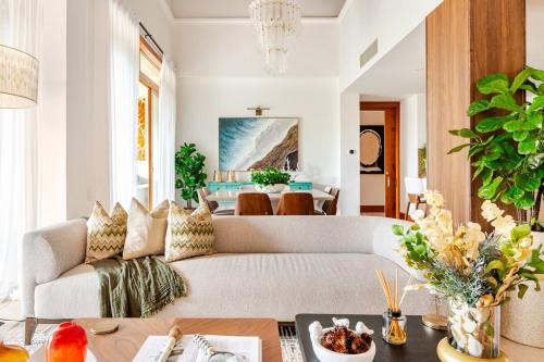 a living room with a couch and a table at Casa Cielo 3 BR Penthouse with Views in La Romana