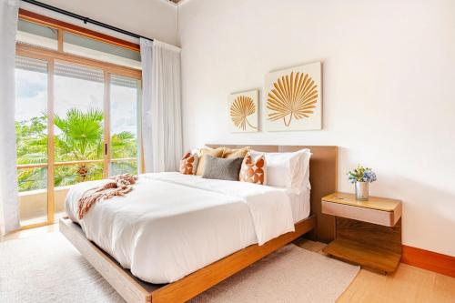 a bedroom with a large bed and a large window at Casa Cielo 3 BR Penthouse with Views in La Romana