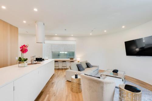a white living room with a couch and a table at Unique Round House, Near State Fair, Modern Luxury in Dallas