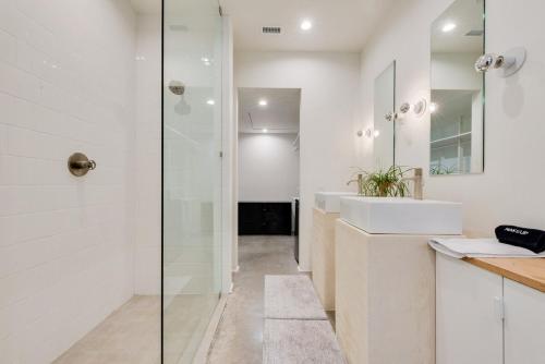 a bathroom with a sink and a glass shower at Unique Round House, Near State Fair, Modern Luxury in Dallas
