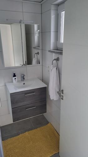 a bathroom with a sink and a mirror at Ferienwohnung mit Sauna und Balkon in Münstermaifeld