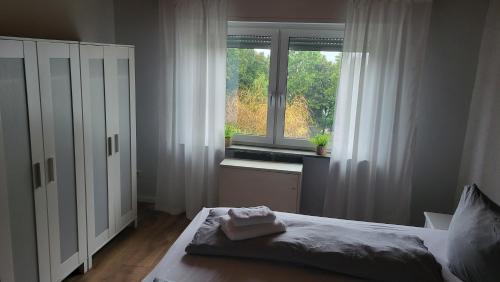 a bedroom with a bed and a window at Ferienwohnung mit Sauna und Balkon in Münstermaifeld