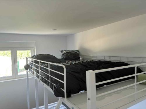 a white bunk bed in a room with a window at Bem estar 3 in Chaves