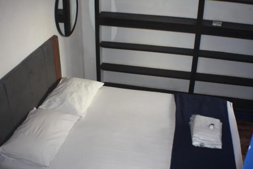 a bed in a room with a pillow on it at Farfalla Guest House in Rio de Janeiro