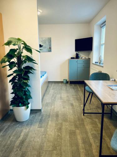 an office with a table and a potted plant at Das SinGold Hotel mit Highspeed WLAN und digitalem Schlüssel in Schwabmünchen