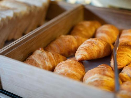 a wooden box filled with lots of croissants at Ibis Styles Linz in Linz