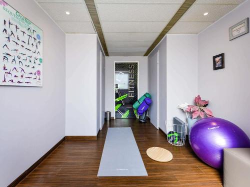 a room with a large purple exercise ball and a large purple exercise ball at Ibis Styles Linz in Linz