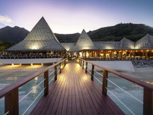 a view of a resort with a boardwalk at Sofitel Kia Ora Moorea Beach Resort in Maharepa