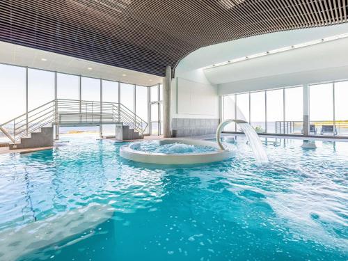 a swimming pool with a tub in the water at Sofitel Quiberon Thalassa sea & spa in Quiberon