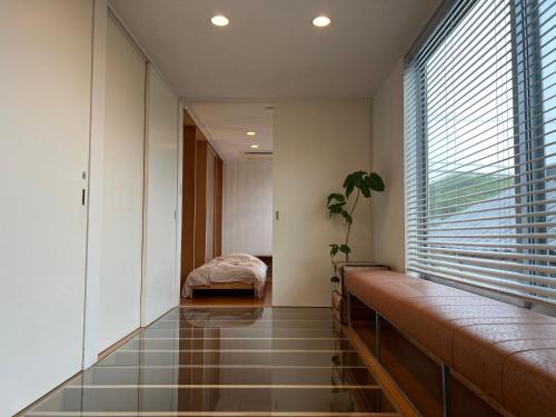 a room with a large window and a bed in it at Urara Holiday in Sumoto