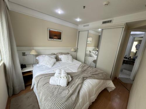 a bedroom with a bed with towels on it at Flat Conforto Luxo Vila Olimpia in Sao Paulo