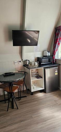 a kitchen with a table and a table and a counter at Westport Kiwi Holiday Park & Motels in Westport