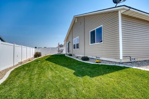a house with a green yard next to a fence at Family Friendly Playroom Garage in Caldwell