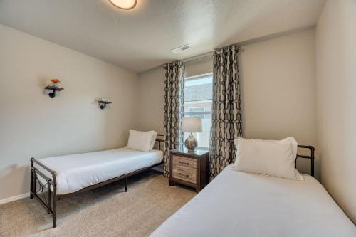 two beds in a room with a window at Family Friendly Playroom Garage in Caldwell