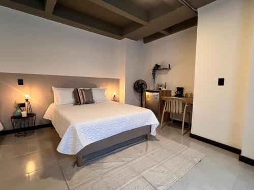 a bedroom with a bed and a dining room with a table at Aparta estudios primer piso con escritorio in Medellín