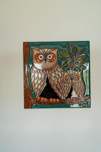 a painting of two owls sitting on a branch at Casa Grace Olón in Olón