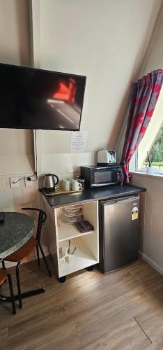 a small kitchen with a sink and a stove at Westport Kiwi Holiday Park & Motels in Westport