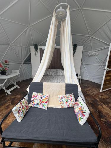 a bed in a yurt with pillows on it at Domo Los Ángeles in Huauchinango