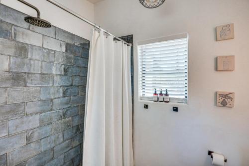 a shower curtain in a bathroom with a stone wall at Casita Anita - Charmer 1 Mi to Dtwn Tucson in Tucson