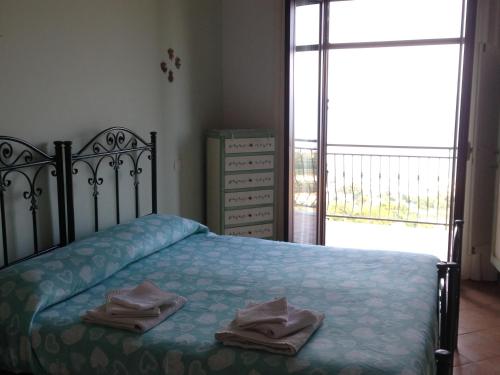 a bedroom with a bed with towels on it at Villa Malandrino Guest House in Agropoli