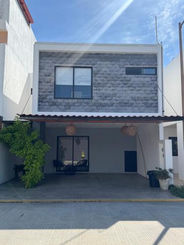 a house with a patio in front of it at Casa Mujer Ceiba - Indoor Pool - We Invoice in Tierra Colorada