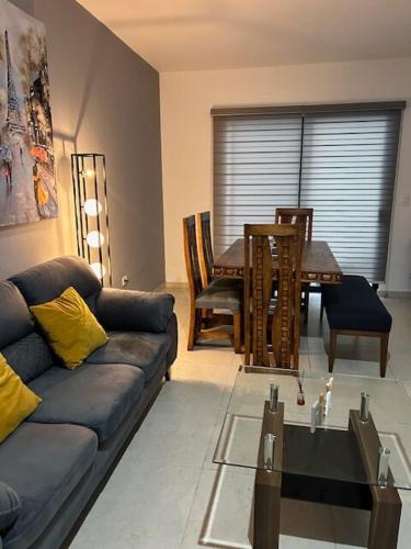 a living room with a couch and a table at Casa Mujer Ceiba - Indoor Pool - We Invoice in Tierra Colorada