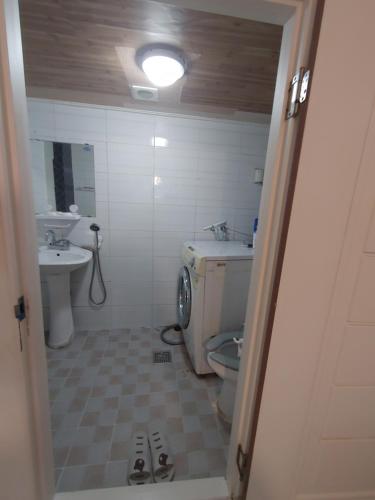 a bathroom with a toilet and a sink at Sinchon House close to the airport in Seoul