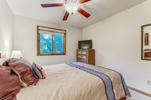 a bedroom with a bed and a ceiling fan at The Great Escape in McCall