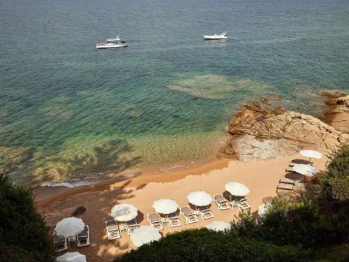 an aerial view of a beach with chairs and umbrellas at Sofitel Golfe d'Ajaccio Thalassa Sea & Spa in Ajaccio