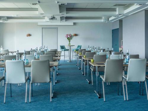 an empty room with tables and chairs in it at Sofitel Golfe d'Ajaccio Thalassa Sea & Spa in Ajaccio