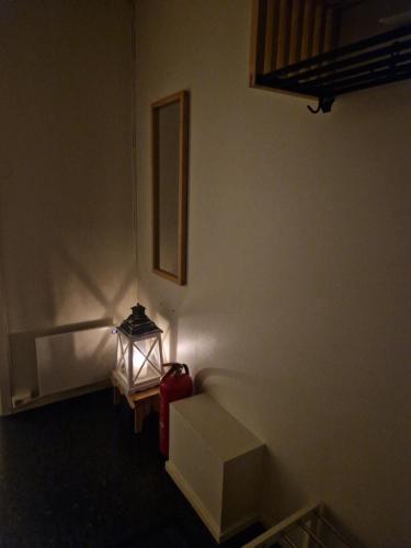 a room with a fire hydrant next to a wall at Warm and cosy apartment in Tromsø