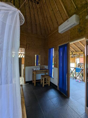 a wedding veil is hanging in a room with a table at AlBambu in Gili Air
