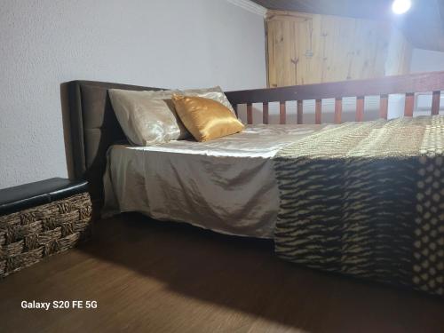 a bed with two pillows on it in a room at Casa inteira Chale e Edicula in Itanhaém
