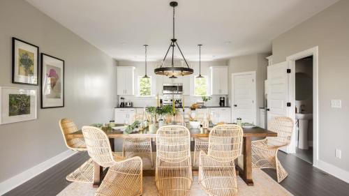 a dining room and kitchen with a table and chairs at Cherokee by AvantStay in Nashville