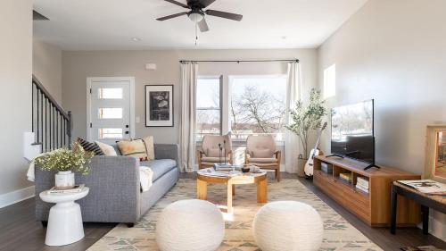 a living room with a couch and a tv at Cherokee by AvantStay in Nashville