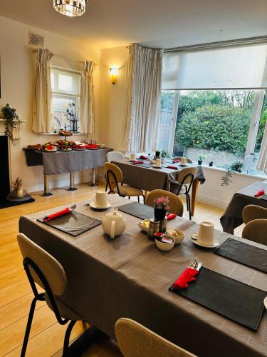 a dining room with a table and a piano at Sonas house in Kilkenny