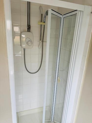 a shower with a glass door in a bathroom at 4 Sisters Inn in North Kyme