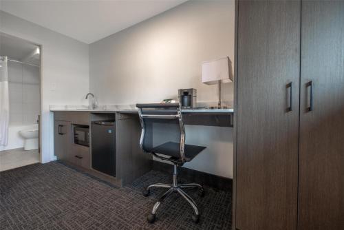 an office with a desk and a chair in a room at Coast Penticton Hotel in Penticton