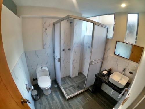 a bathroom with a shower with a toilet and a sink at Samana Wasi in Cusco