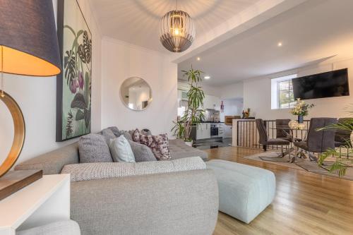 a living room with a couch and a table at Little Townhouse Funchal in Funchal