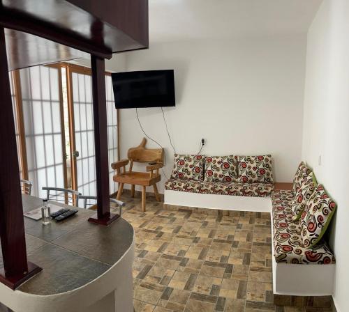 a living room with a couch and a chair at Apartment Laureles in Santa Lucía
