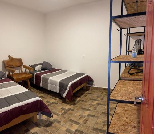 a room with two beds and a bunk bed at Apartment Laureles in Santa Lucía