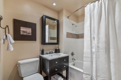 a bathroom with a toilet and a sink and a shower at Small Town Feel Big Mountain Access in Frisco