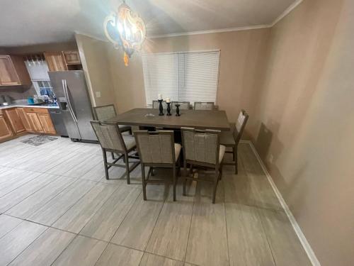a kitchen with a dining room table and chairs at Khawaja Home in High Point