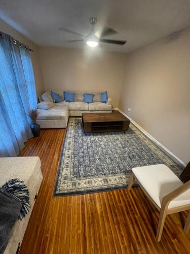 a living room with a couch and a table at Khawaja Home in High Point