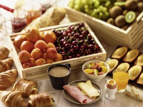 a table topped with lots of different types of food at ibis Nice Aéroport Promenade des Anglais in Nice