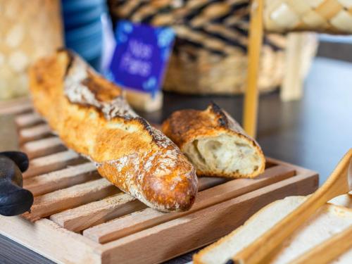 two loaves of bread sitting on a grill at Mercure Epinal Centre in Épinal